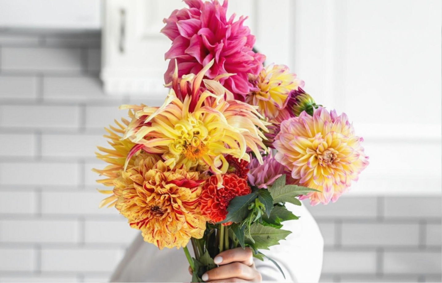Floristry instructor reviewing parallel arrangement technique with a student during a live session